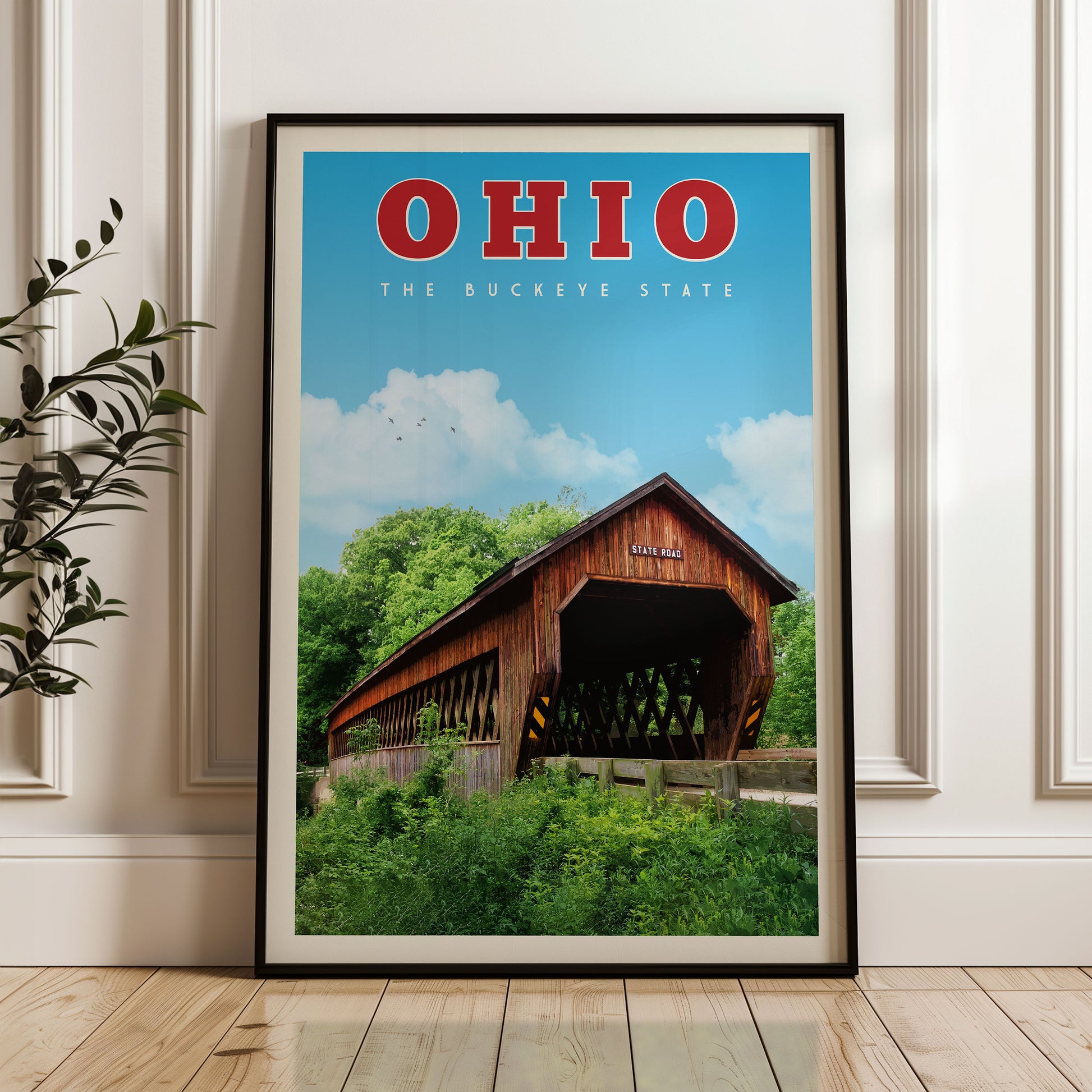 A framed poster of a covered bridge in Ohio, with the state name "OHIO" prominently displayed at the top.
