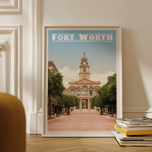 A framed poster of the Fort Worth, Texas cityscape, featuring a large building with a clock tower and surrounded by trees.