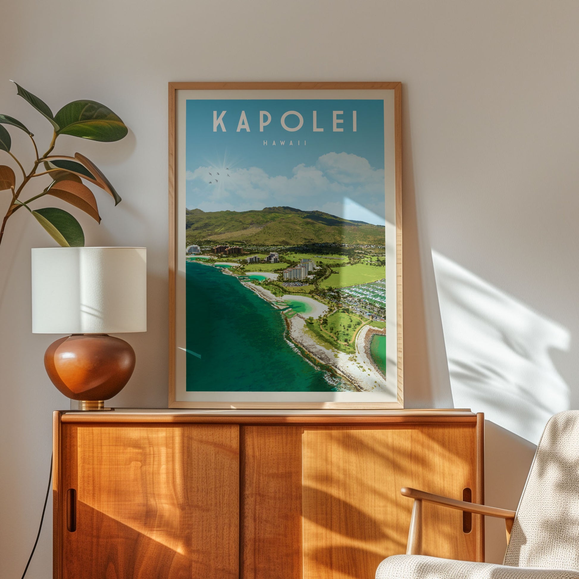 a framed poster of a scenic coastal landscape, with the word "KAPOLEI" prominently displayed. The poster is hanging on a wall, and there is a lamp and a wooden cabinet below it.