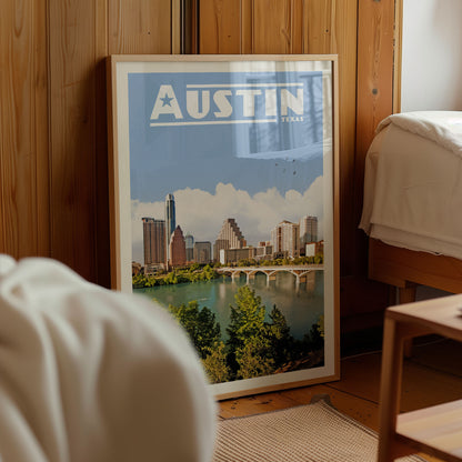 A framed poster of the Austin skyline, featuring the city's iconic landmarks, is displayed in a room with wooden walls.