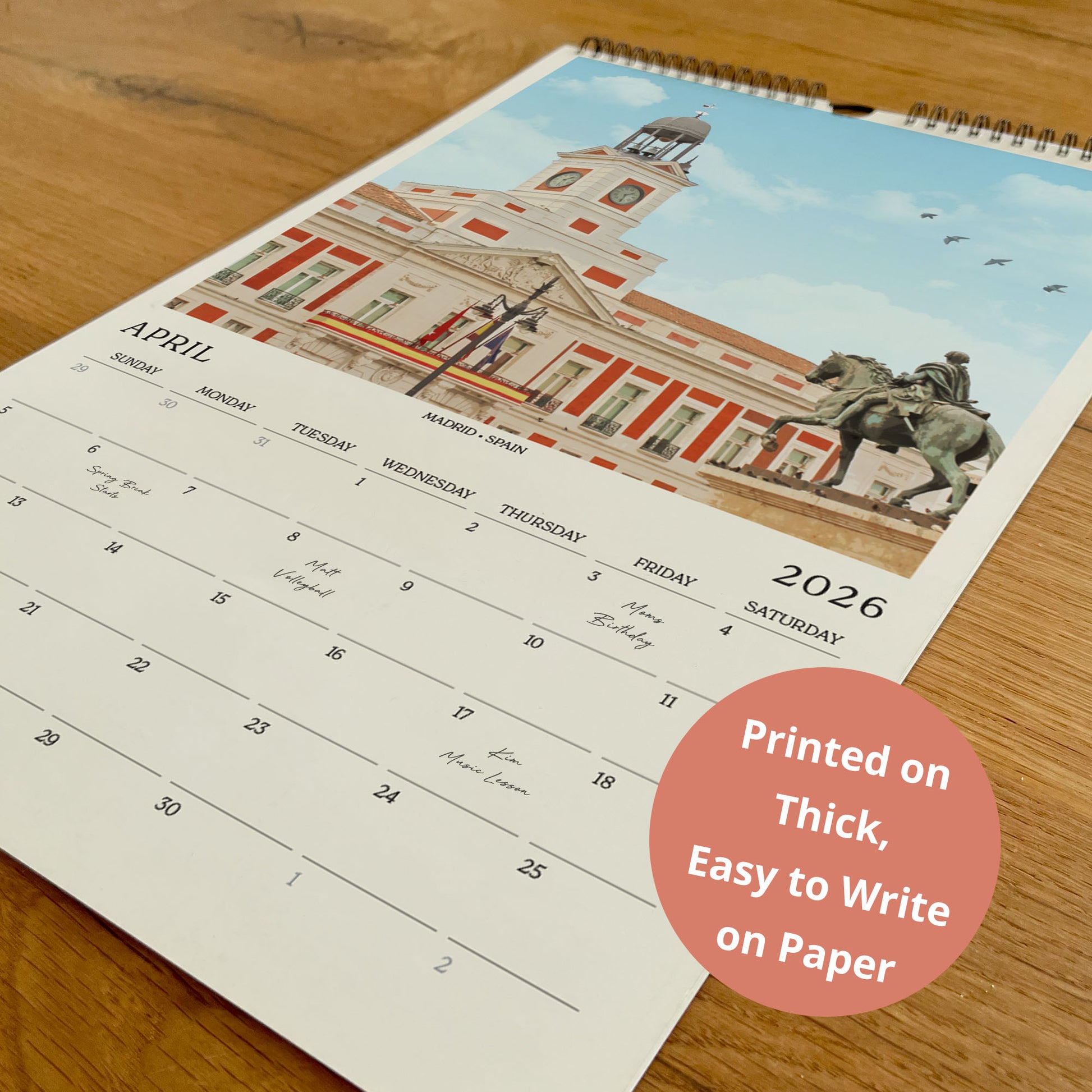 A wall calendar with a photo of a building and a statue on the cover, printed on paper.