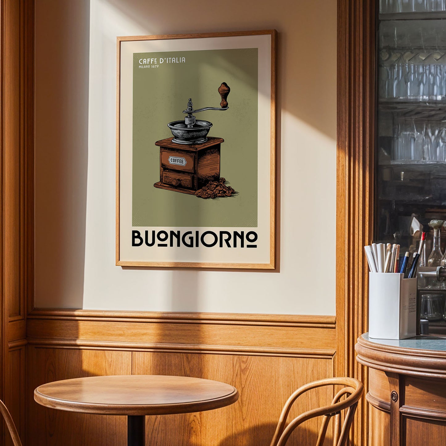 a framed poster of a coffee grinder on a wall, with a wooden table and chairs in the foreground.