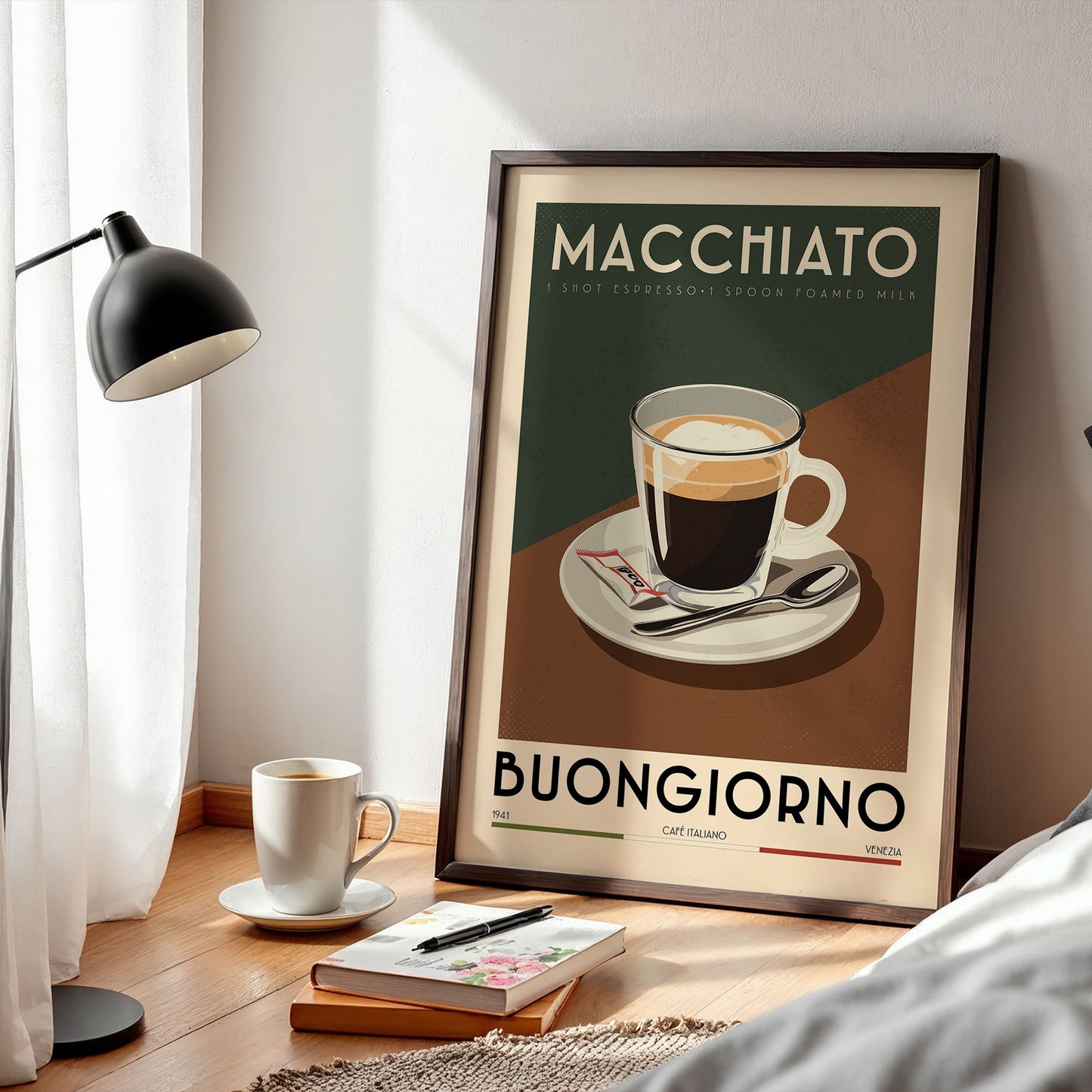 a framed poster of a cup of coffee with the text "MACHIATO" and "BUNGGIORNO" printed on it, along with a cup of coffee and a book on a wooden table.