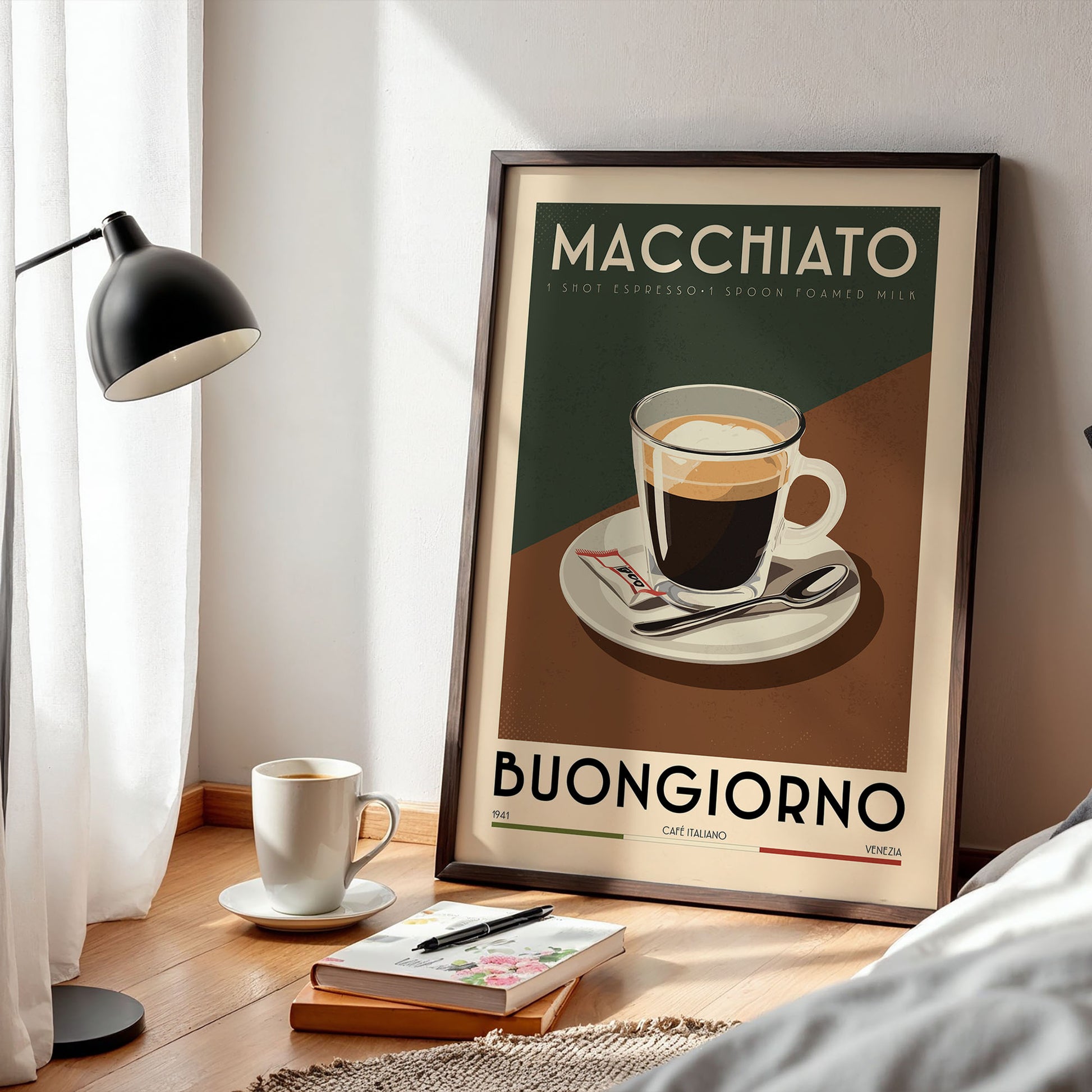 a framed poster of a cup of coffee with the text "MACHIATO" and "BUNGGIORNO" printed on it, along with a cup of coffee and a book on a wooden table.