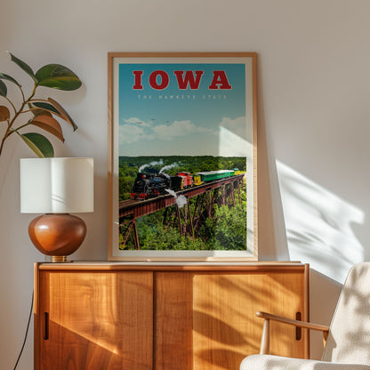 a framed poster of a train on a bridge, with the word "IOWA" prominently displayed.