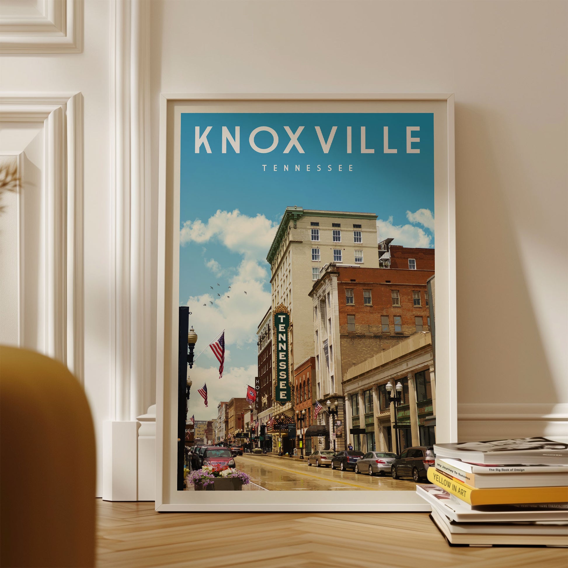 A framed poster of Knoxville, Tennessee, depicting a city street with buildings, cars, and a clear blue sky.