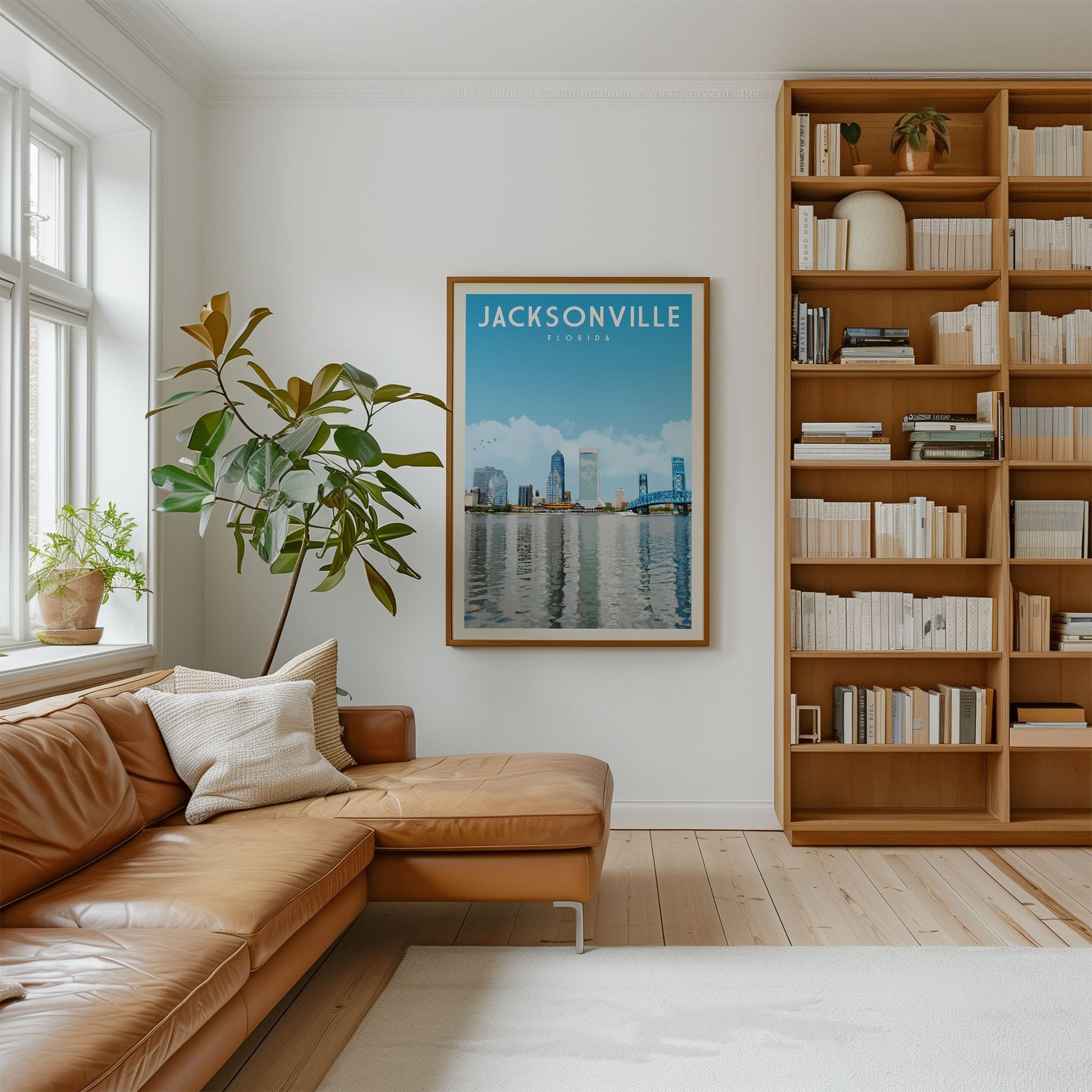 a cozy living room with a large window, a comfortable leather couch, a bookshelf filled with books, and a framed poster of a city skyline hanging on the wall.