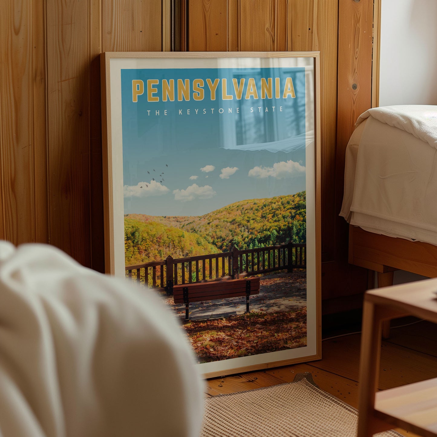 A framed poster of a scenic outdoor landscape in Pennsylvania, featuring a bench and a forested area.