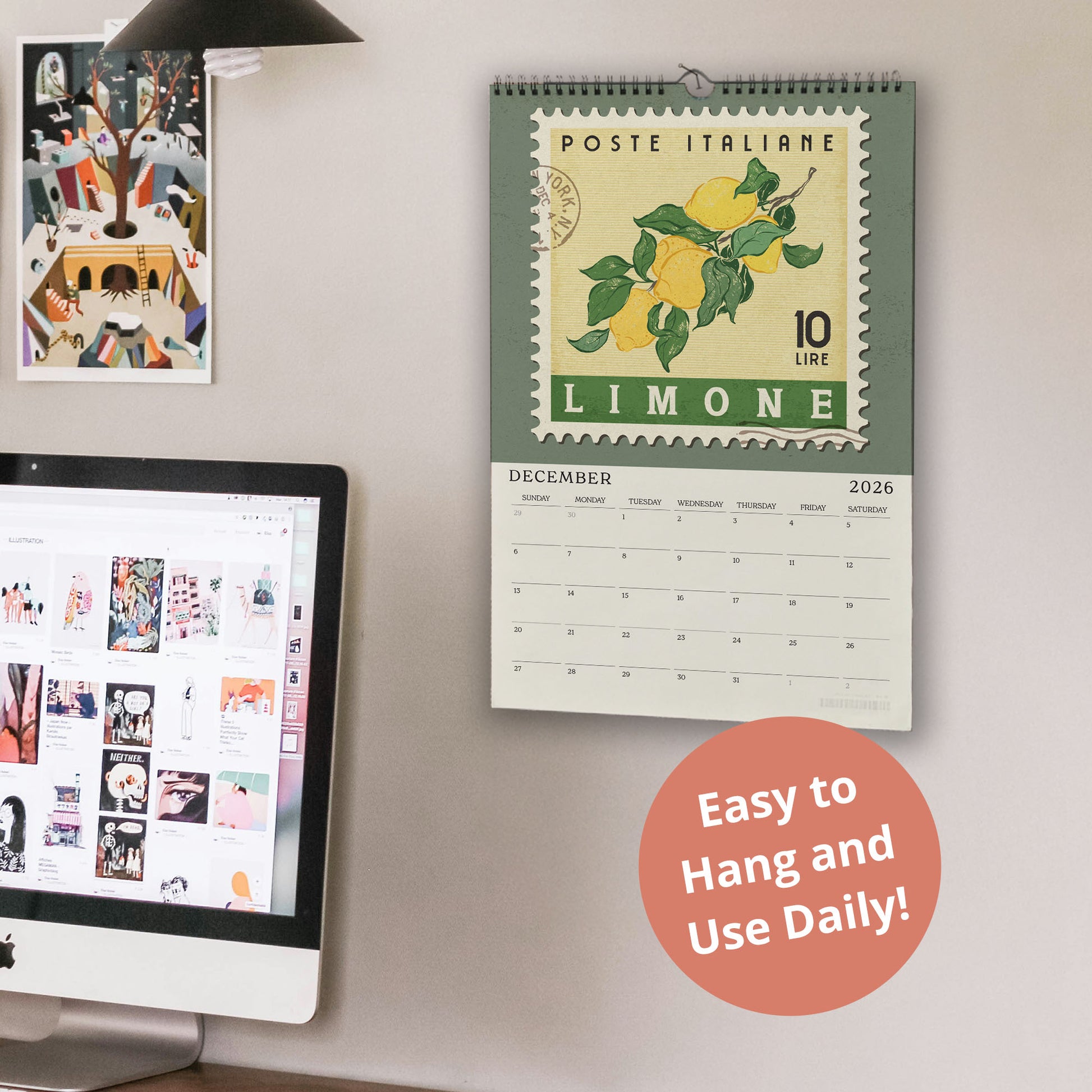 a wall calendar with a green border and a stamp design, hanging on a wall next to a computer monitor displaying a webpage.