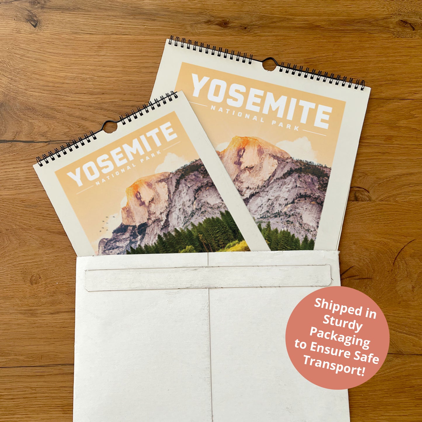 A calendar for Yosemite National Park is placed inside a white envelope on a wooden surface.