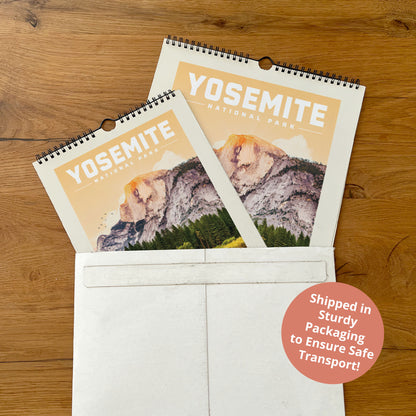 A calendar for Yosemite National Park is placed inside a white envelope on a wooden surface.