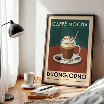 a framed poster of a coffee mug with a whipped cream topping, placed on a wooden table next to a lamp and a book.