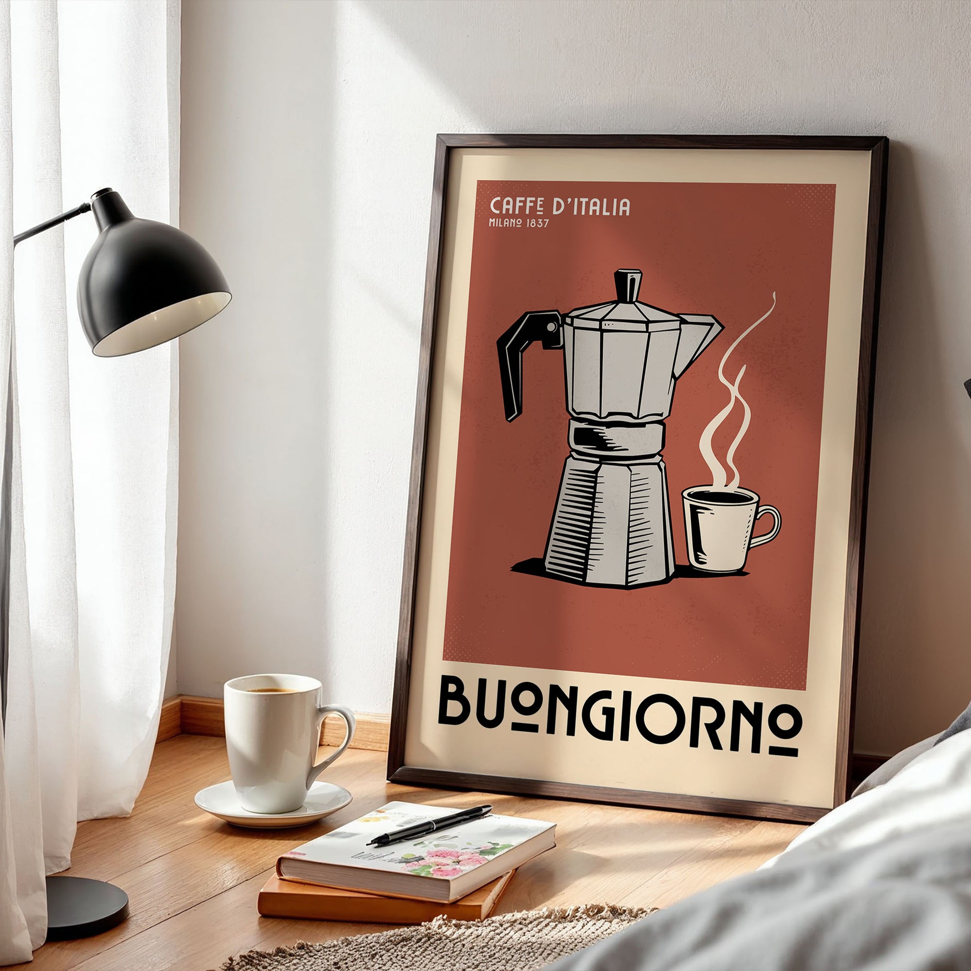 a framed poster of a coffee maker with a cup of coffee next to it, placed on a wooden floor next to a lamp and some books.