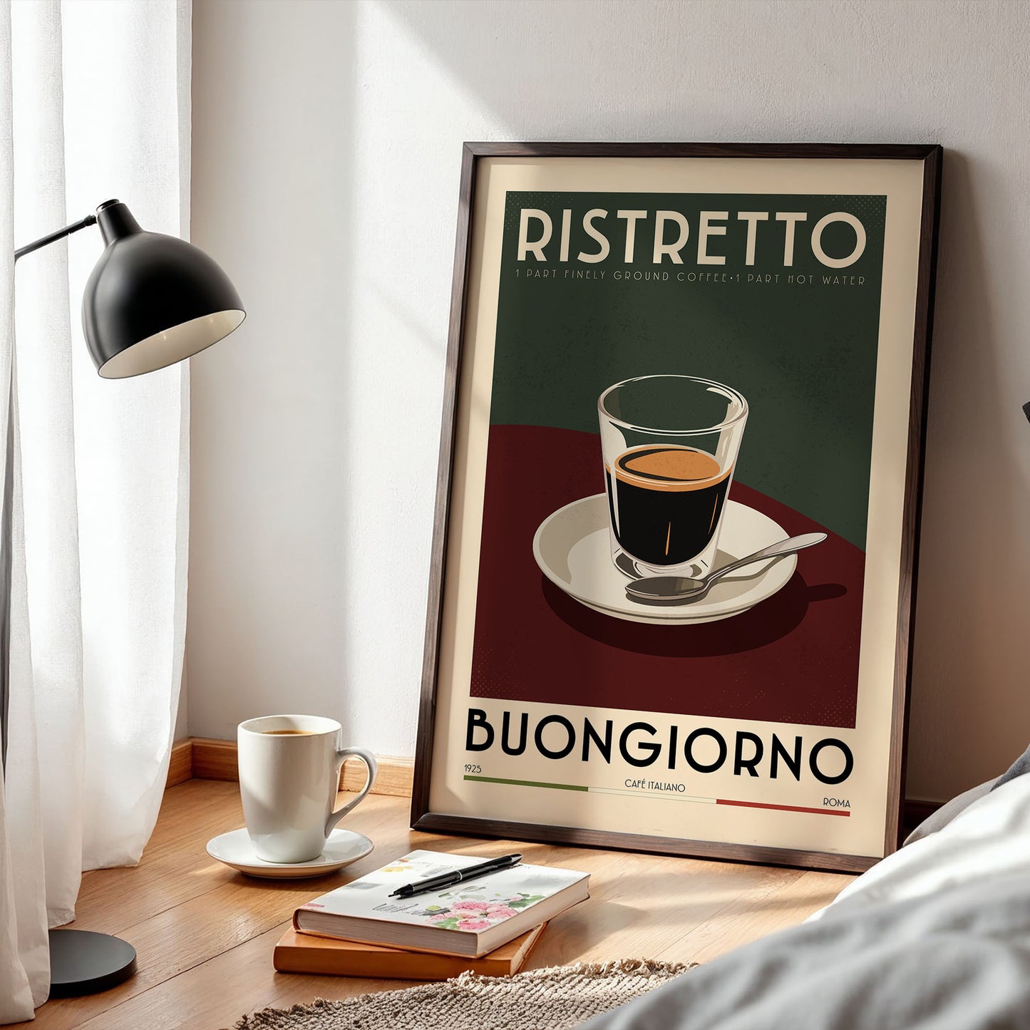 a framed poster of a cup of coffee with the text "RISTRETO" and "BUONGIORNO" printed on it, along with a cup of coffee and a book on a wooden table.