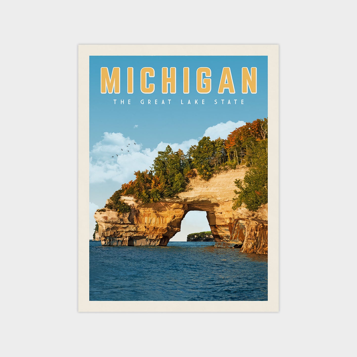 A framed poster depicting the Great Lakes State of Michigan, featuring a scenic view of the lake surrounded by rocky cliffs and autumn foliage.