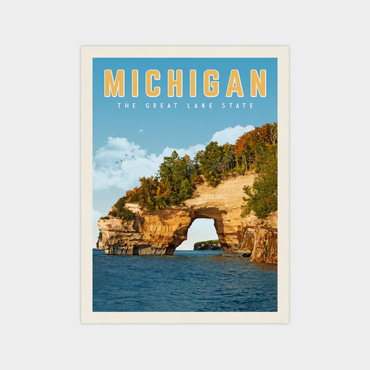 A framed poster depicting the Great Lakes State of Michigan, featuring a scenic view of the lake surrounded by rocky cliffs and autumn foliage.