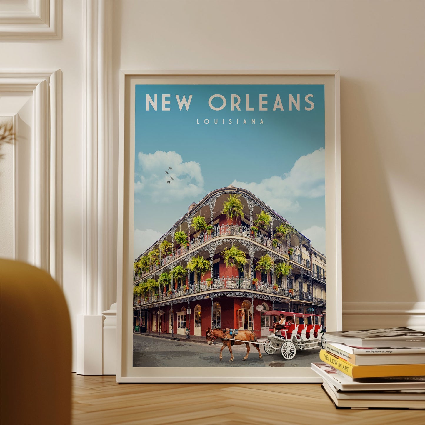 A framed poster of the New Orleans, Louisiana, street scene with a horse-drawn carriage, surrounded by books and a white wall.