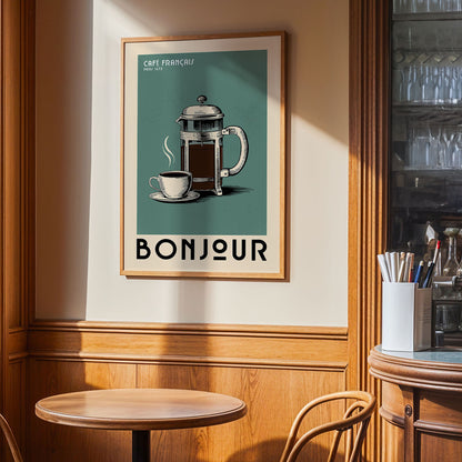 a framed poster of a French coffee pot and cup, with the text "BONJOUR" prominently displayed, hanging on a wall in a cafe or restaurant setting.