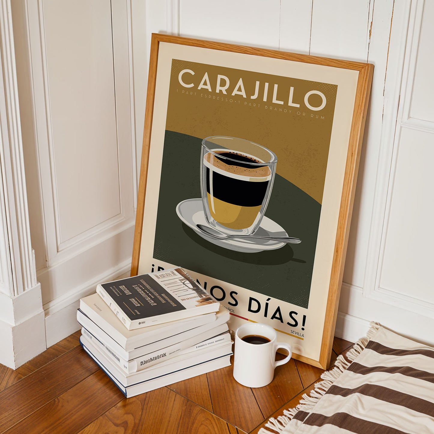 a framed poster of a cup of coffee with a stack of books and a white mug on the floor in front of it.