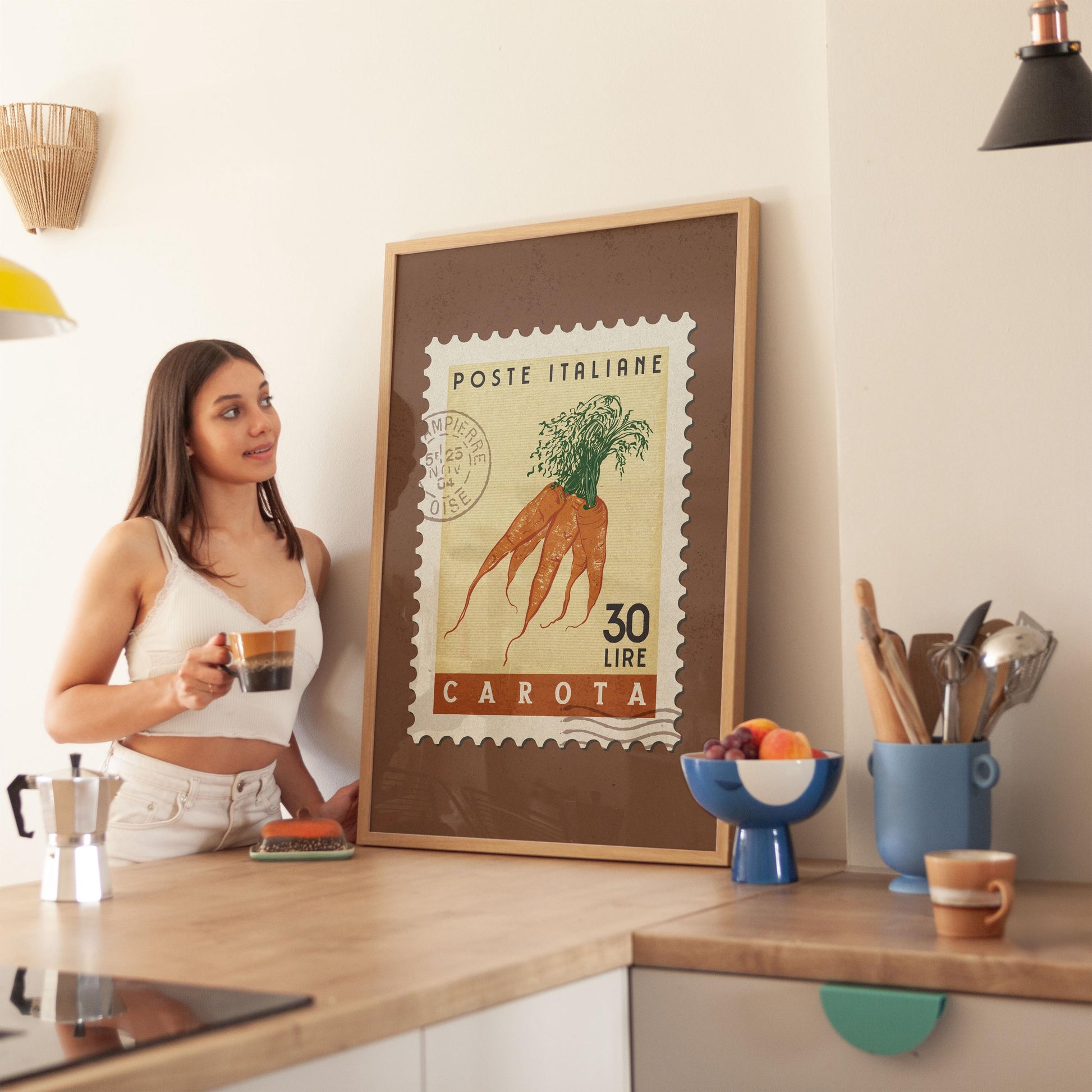 a woman standing in a kitchen holding a cup