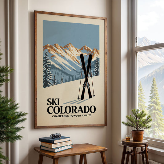 a framed poster of a mountain landscape with ski equipment, hanging on a wall in a room with a window and a small table with books and a plant.