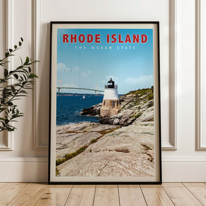 A framed poster of a lighthouse on a rocky coastline, with a bridge in the background, is displayed on a wall.