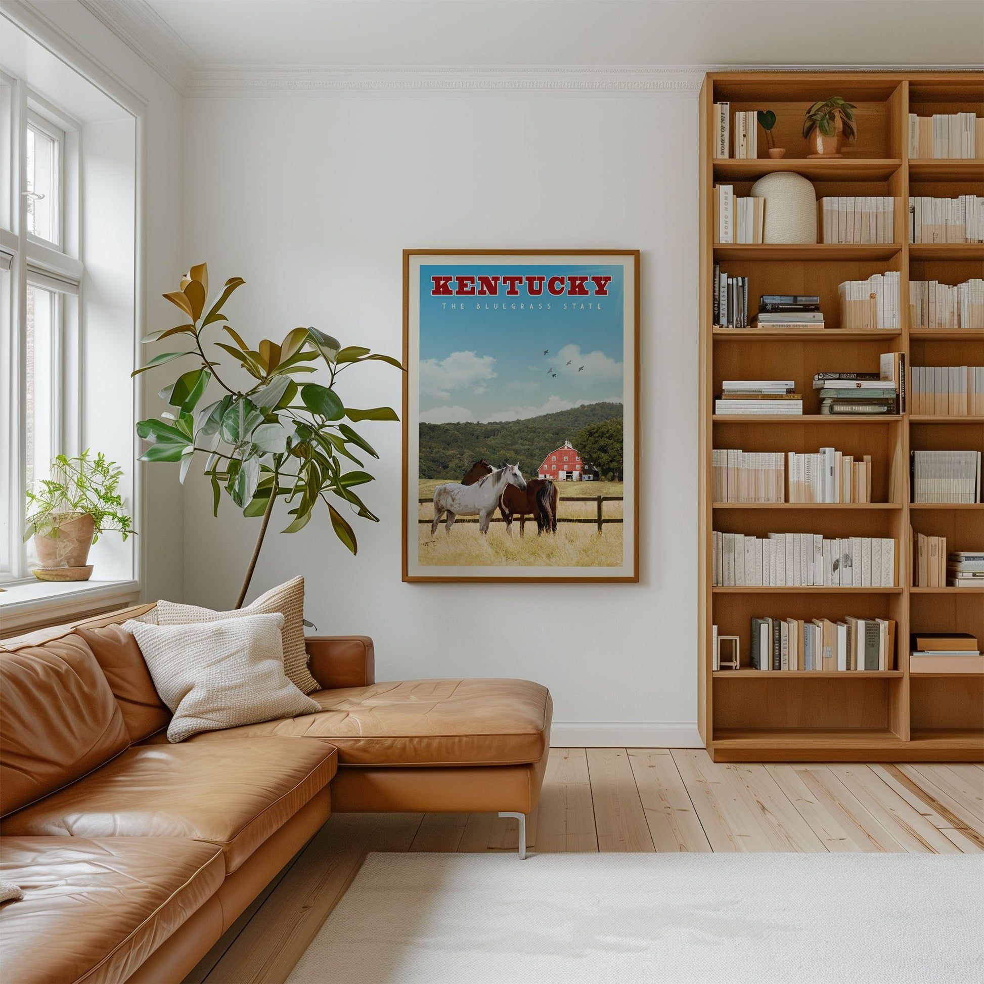 a cozy living room with a large bookshelf filled with books, a comfortable leather couch, and a framed poster of horses in Kentucky hanging on the wall.