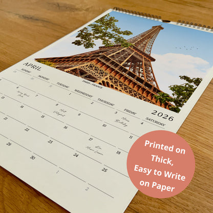 A wall calendar with a photo of the Eiffel Tower on the cover, and the text "Printed on Thick, Easy to Write on Paper" in the bottom right corner.