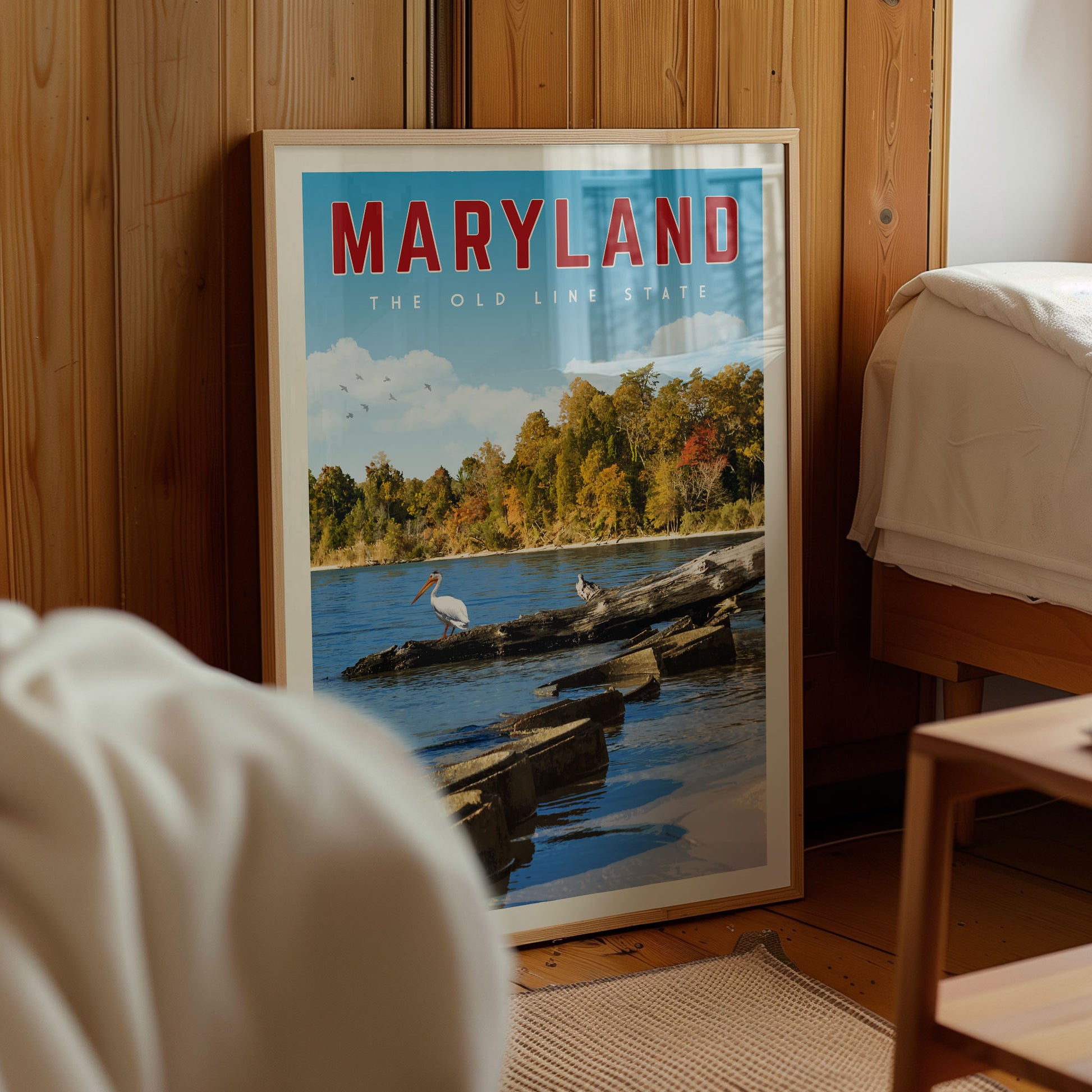 A framed poster of a scenic view of the shoreline in Maryland, featuring a bird and a body of water.