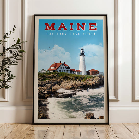 A framed poster of a lighthouse on a rocky coastline, with the text "MAINE THE PINE TREE STATE" above it.