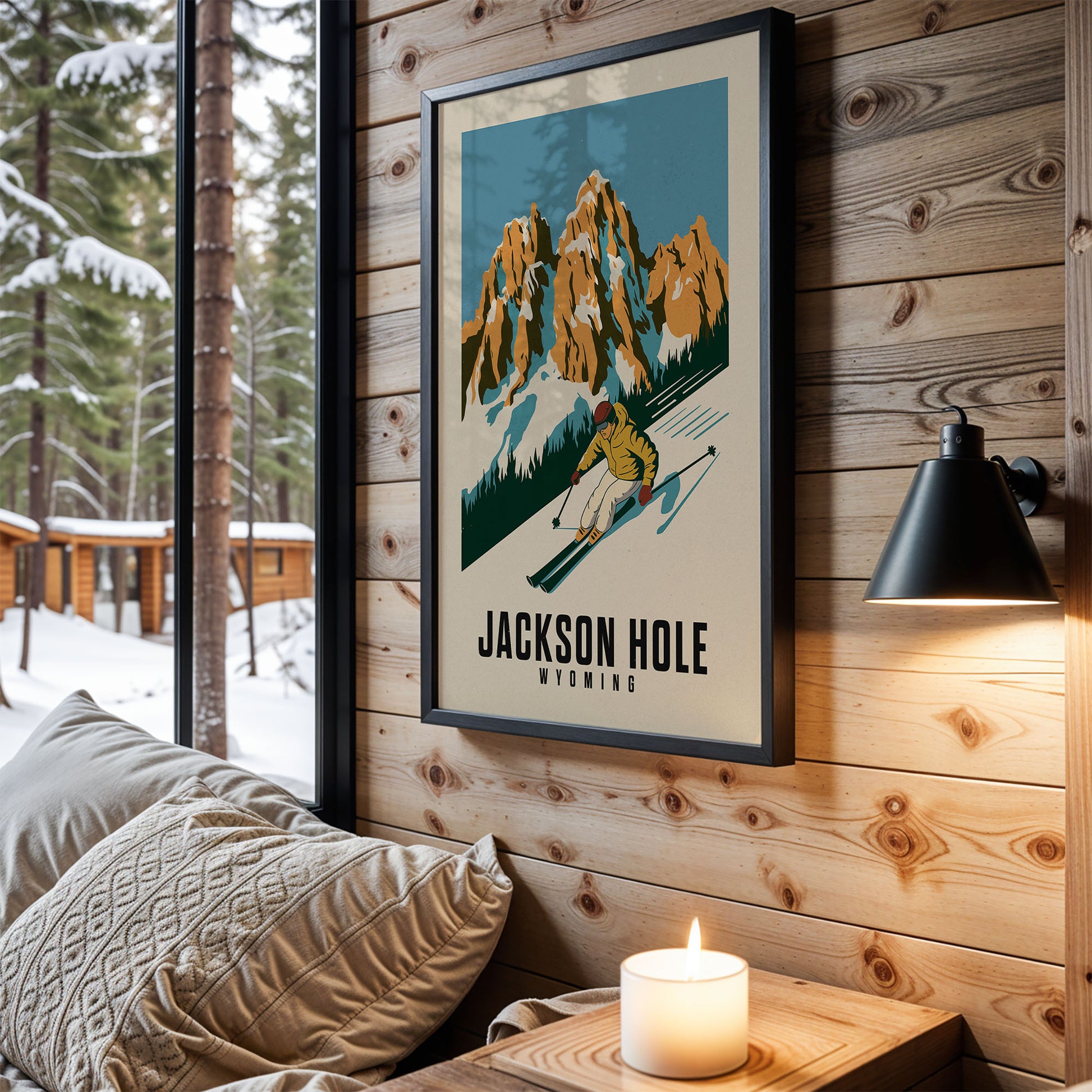 A framed poster of a skier in the Jackson Hole region hangs on a wooden wall, with a cozy bed and a lit candle in the foreground.