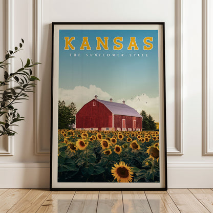 A framed poster of a red barn surrounded by a field of sunflowers, with the text "KANSAS THE SUNFLOWER STATE" prominently displayed.