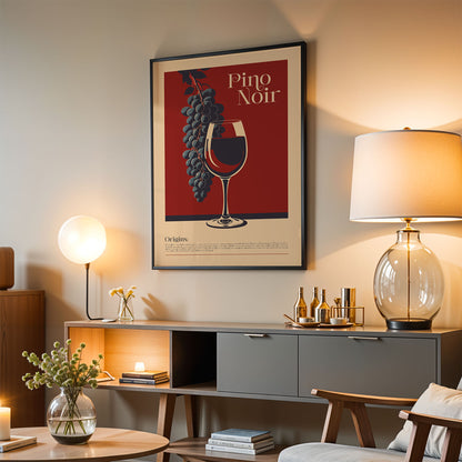 a living room with a framed poster of a wine glass and grapes hanging on the wall, a wooden cabinet with a lamp and decorative items, and a chair in the foreground.