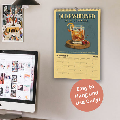 a wall with a calendar for September 2021 hanging on it, a computer monitor, and a desk with a laptop.