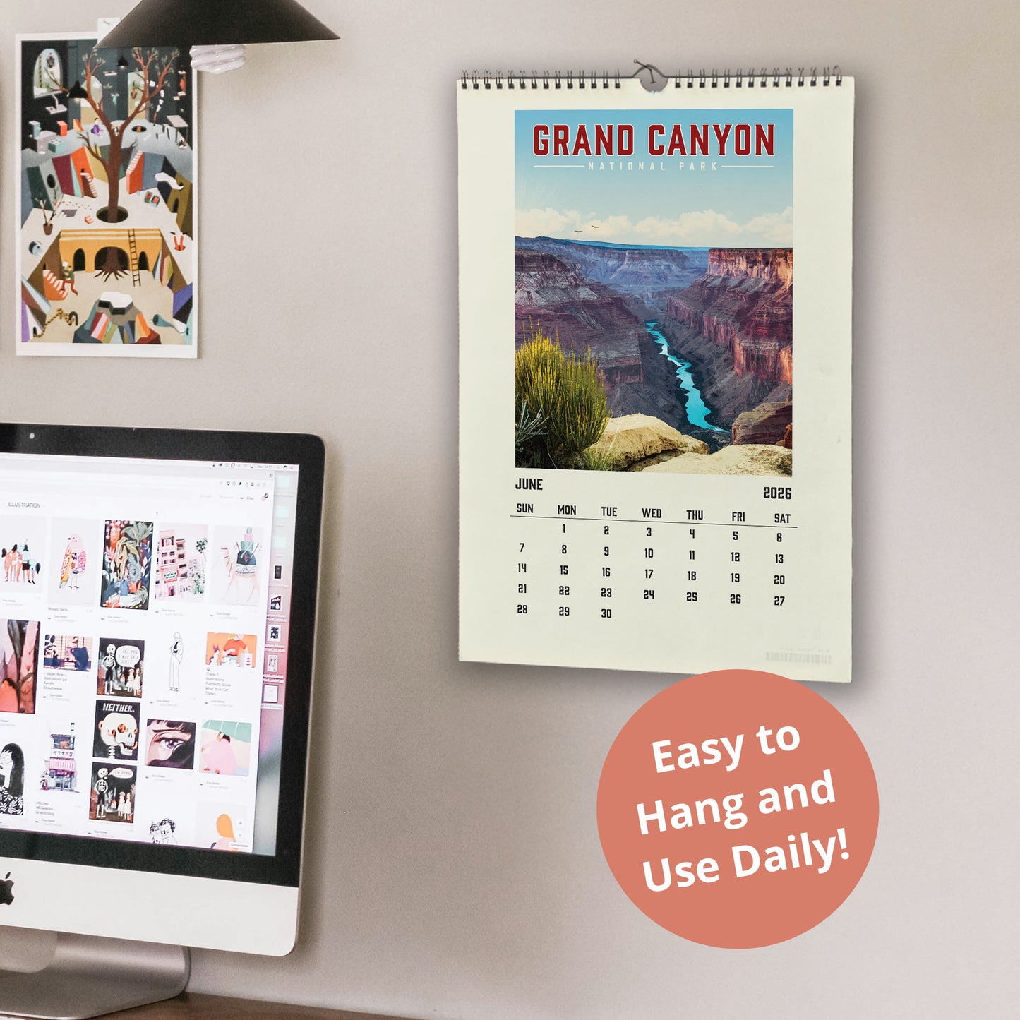 a wall with a calendar for the Grand Canyon, a computer monitor displaying a webpage, and a desk with a laptop. The calendar is hanging on the wall and the desk is also visible.