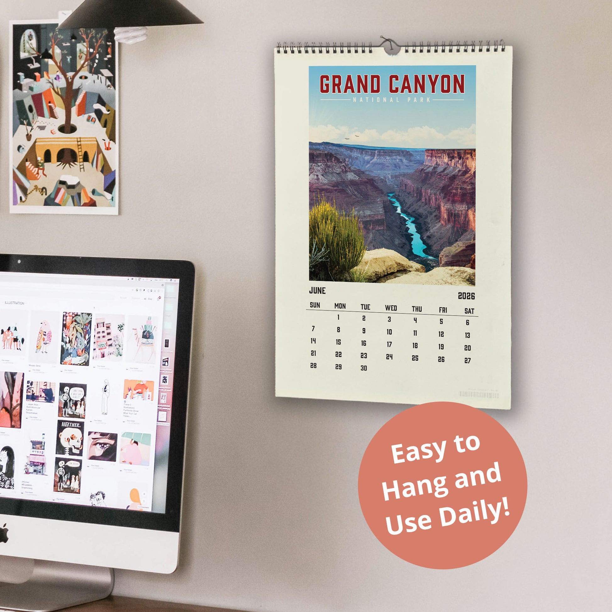 a wall with a calendar for the Grand Canyon, a computer monitor displaying a webpage, and a desk with a laptop. The calendar is hanging on the wall and the desk is also visible.