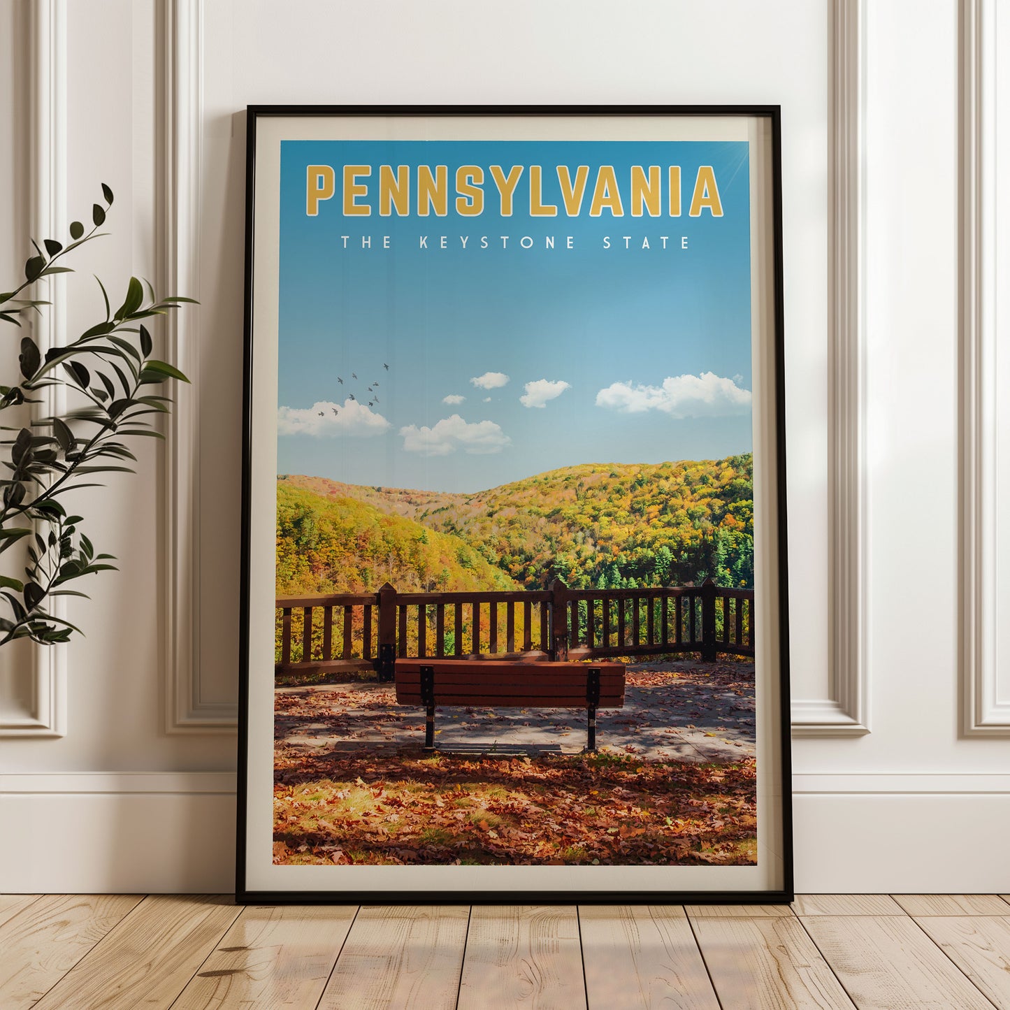 A framed poster of a scenic autumn landscape in Pennsylvania, featuring a bench overlooking a forested hillside.