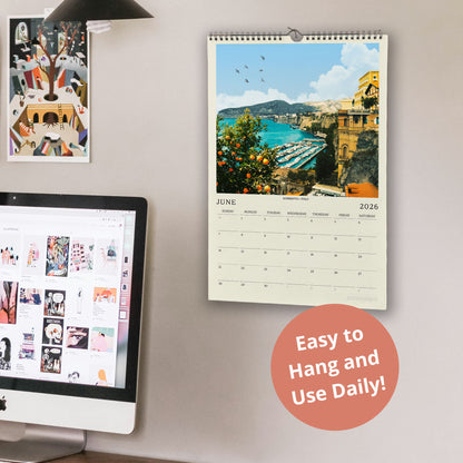 a wall with a calendar and a computer monitor, along with a few other items. The calendar displays a scenic view of a coastal town, and the computer monitor shows a webpage with various images. There is also a text overlay that reads "Easy to Hang and Use Daily!"