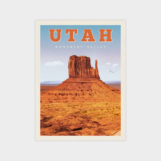 A poster of Monument Valley, a famous landmark in Utah, USA. The poster features a large, rocky formation against a clear blue sky, with a few birds flying in the distance.