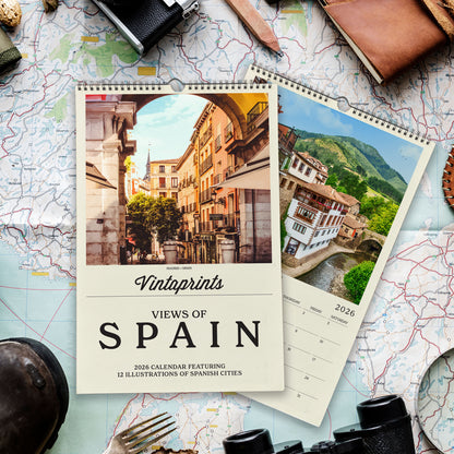 a calendar with a photo of a city and a map of Spain, along with various travel-related items such as a camera, a magnifying glass, and a pocket watch.