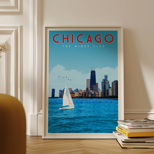 A framed poster of Chicago, featuring a sailboat on the water with the city skyline in the background.