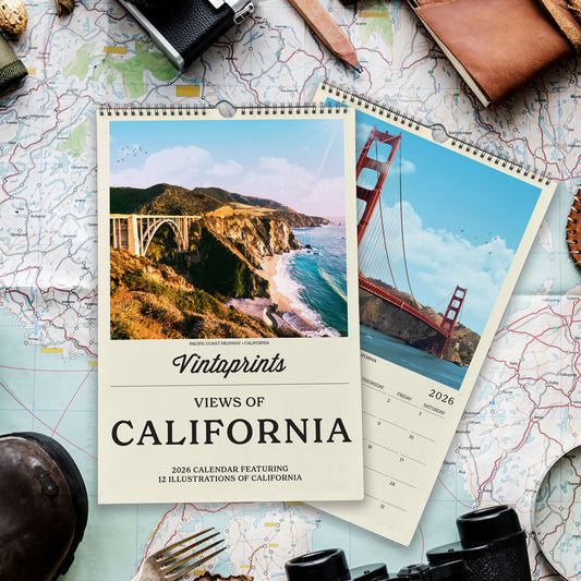 a calendar with a scenic view of California, including the Golden Gate Bridge and other natural landscapes. The calendar is surrounded by various travel-related items, such as a map, a camera, a notebook, and a pair of binoculars.