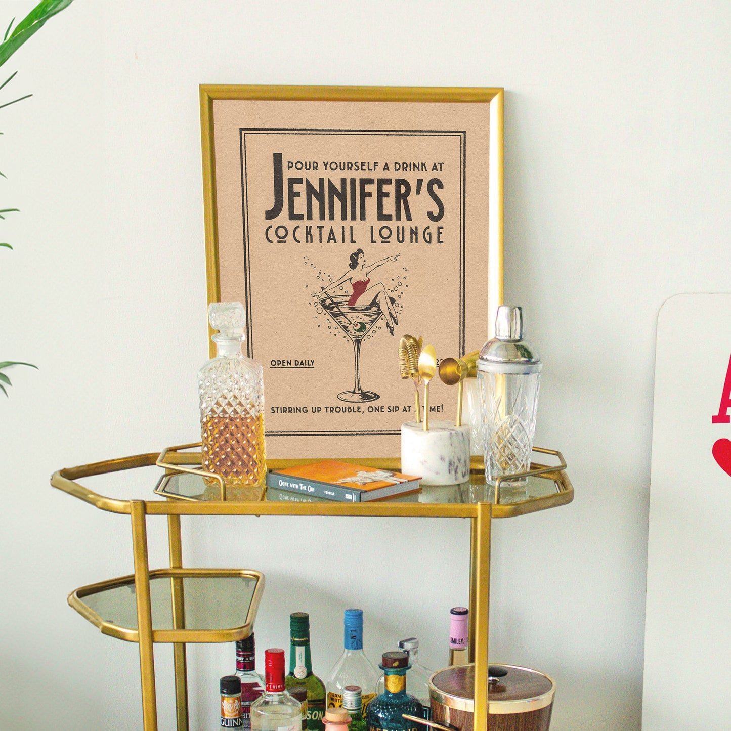 a gold bar cart with liquor bottles on it