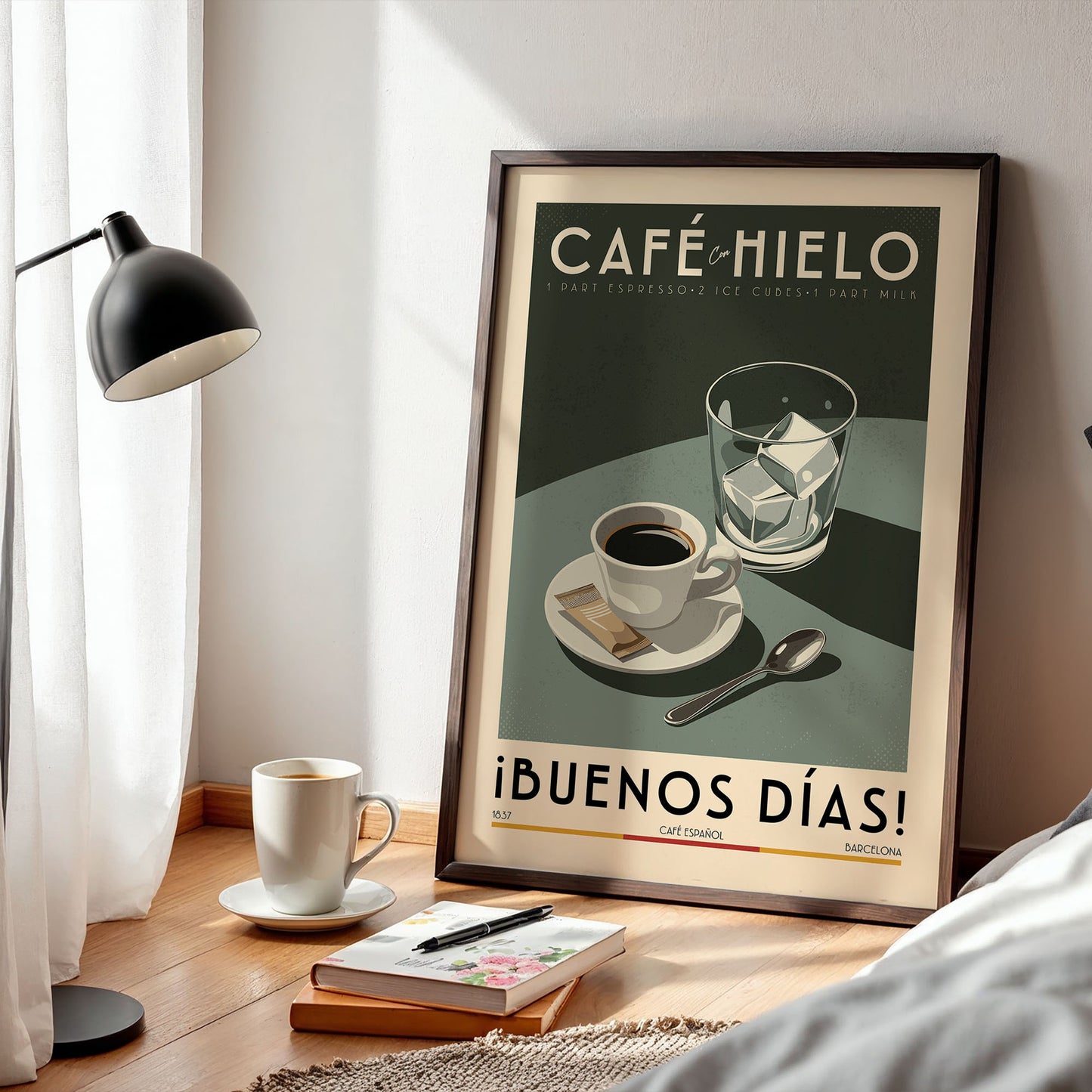 a framed poster of a coffee scene, with a cup of coffee, a glass of ice, and a spoon on a table. There is also a lamp and a book on the table.