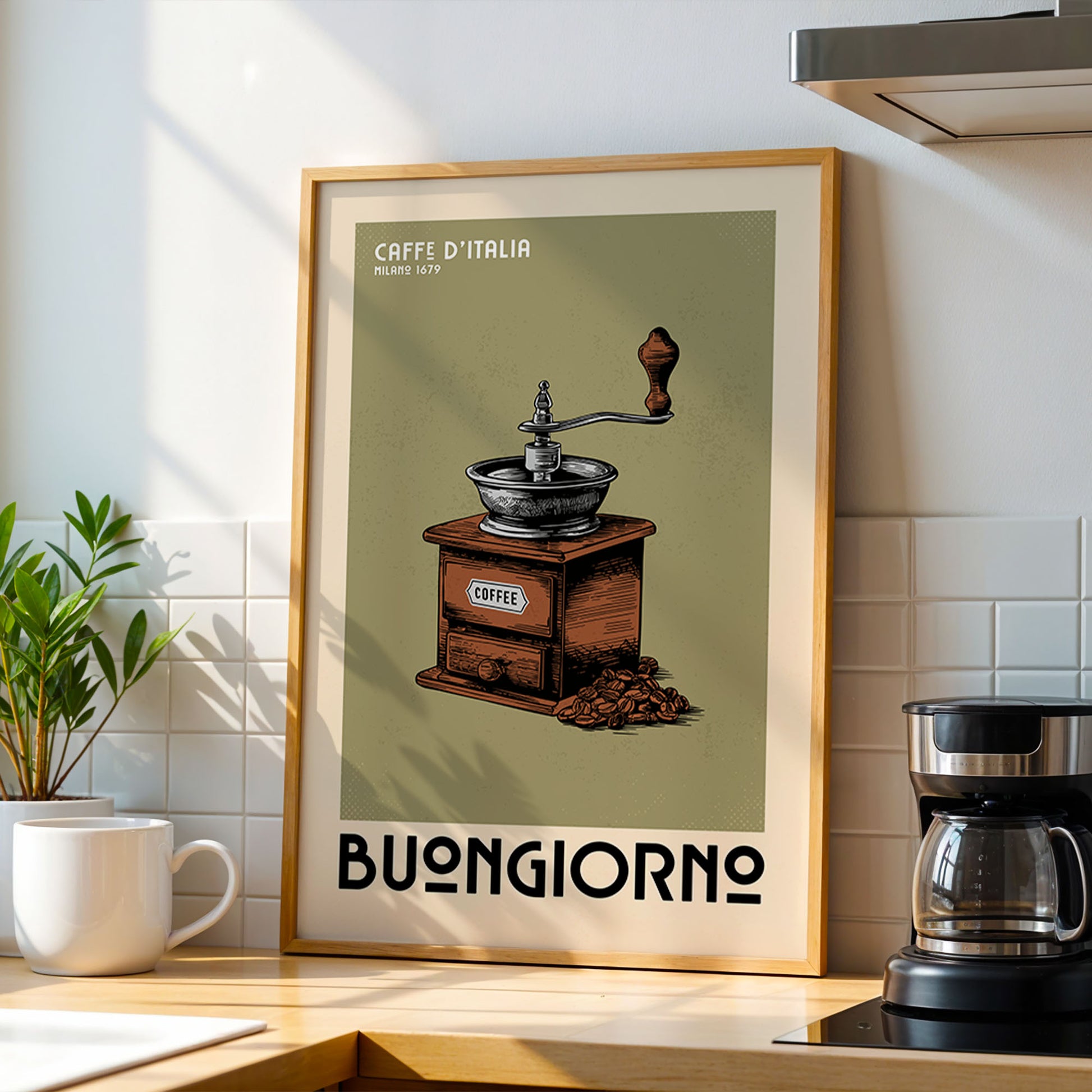 a framed poster of a coffee grinder with the text "CAFFE DI ITALIA MILANO 1772 BUONGIORNO" on it, placed on a kitchen counter next to a coffee maker.