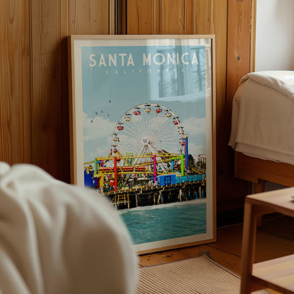 A framed poster of Santa Monica, California, featuring a ferris wheel and the ocean in the background.