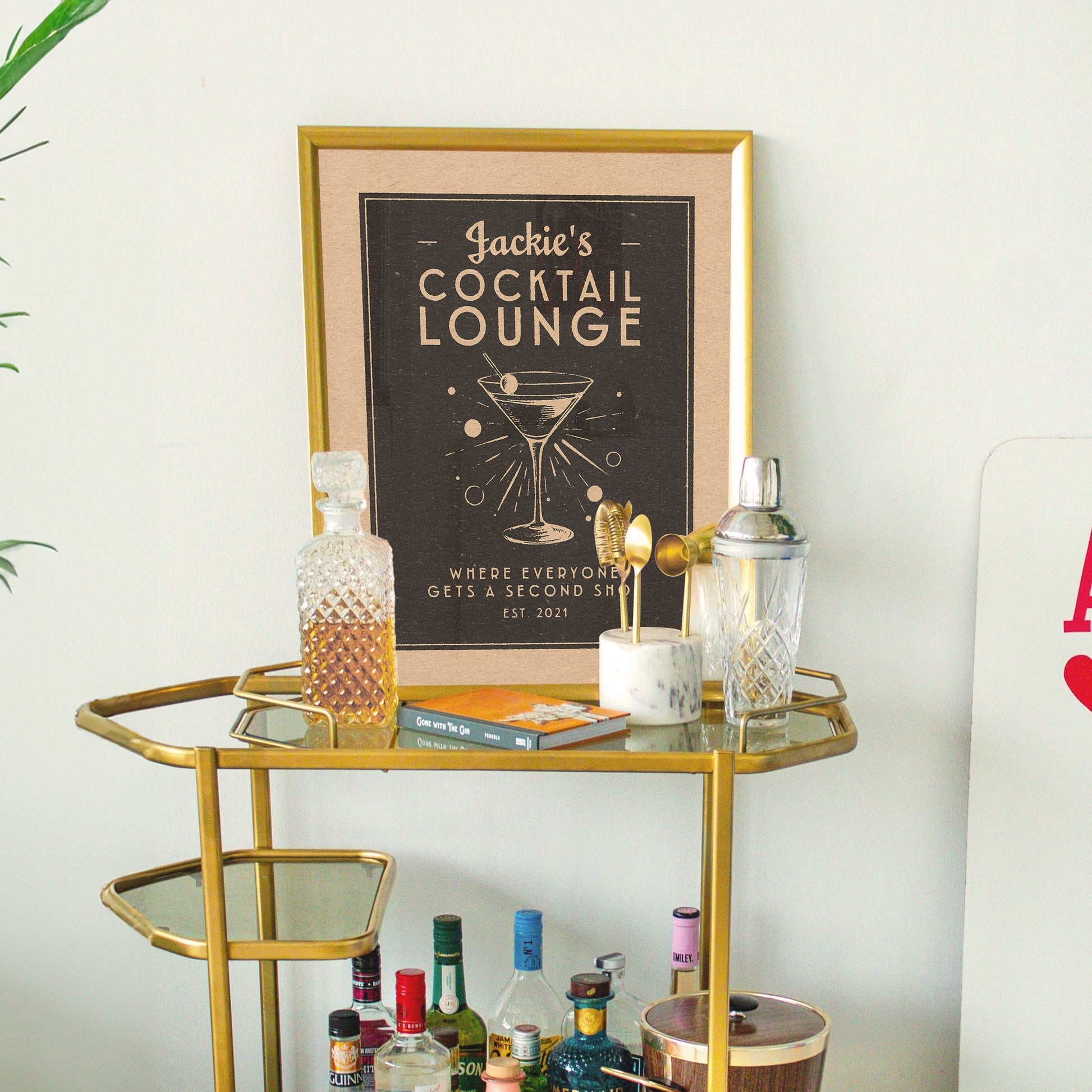 a gold bar cart with drinks on it