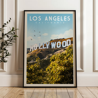 A framed poster of the Hollywood sign in Los Angeles, California, with a scenic landscape in the background.