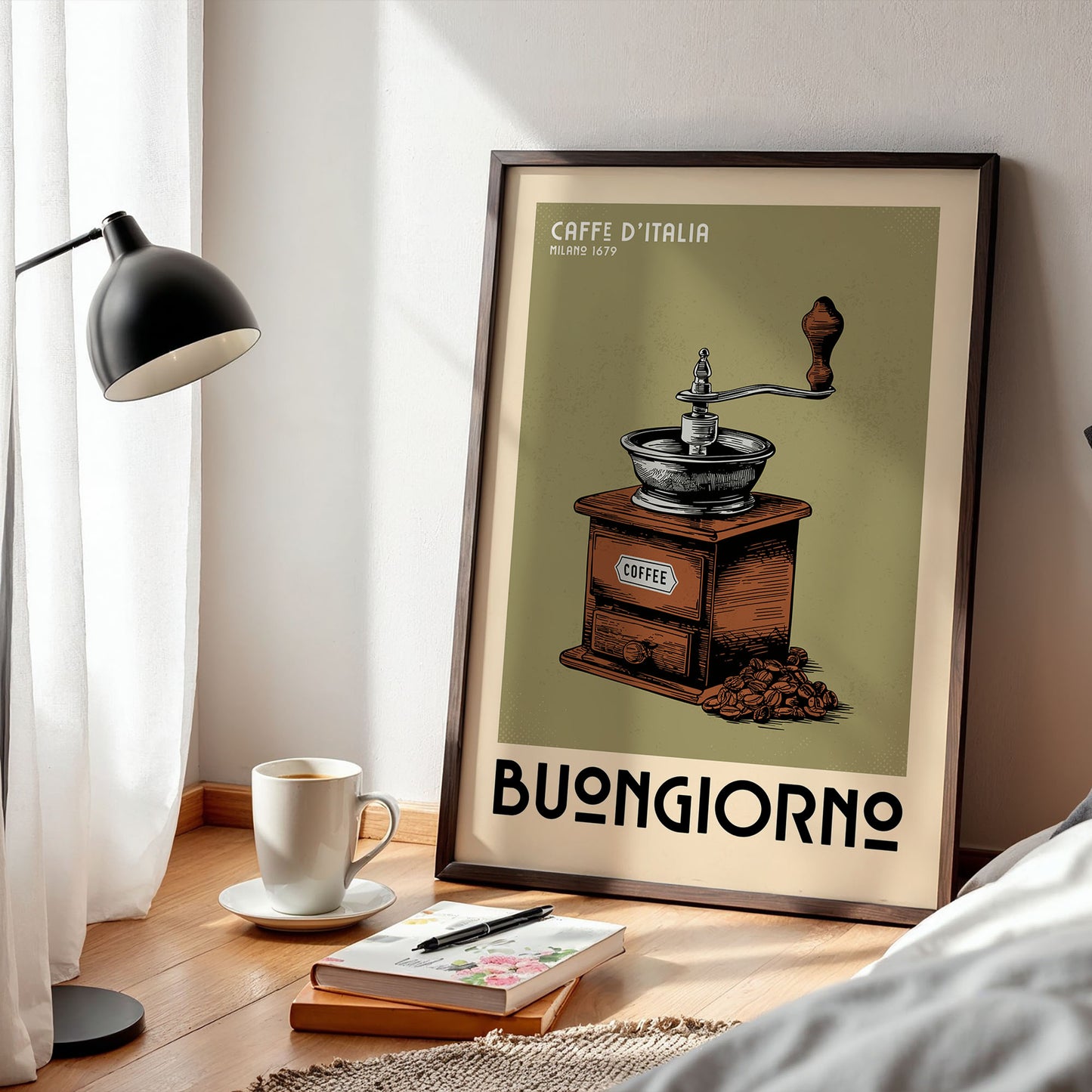 a framed poster of a coffee grinder with the text "Caffè d'Italia" and "Milano 1679" on it, along with the word "BONIGIORNO" below. The poster is displayed on a wooden floor next to a lamp, a cup of coffee, and a book.