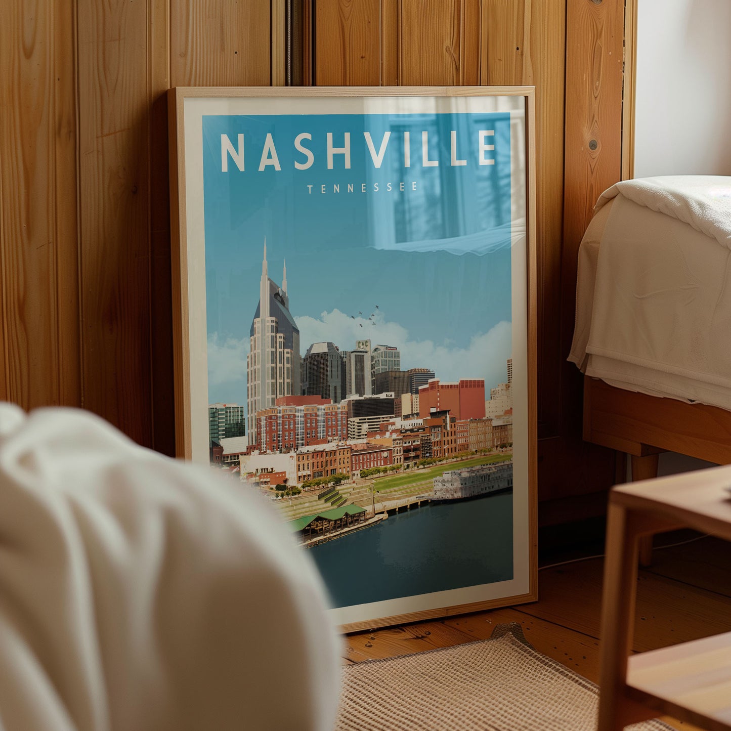 A framed poster of Nashville, Tennessee, featuring the city's skyline and surrounding areas.